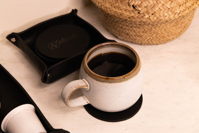 Black Round Leather Coaster Set display with Coffee and Tray