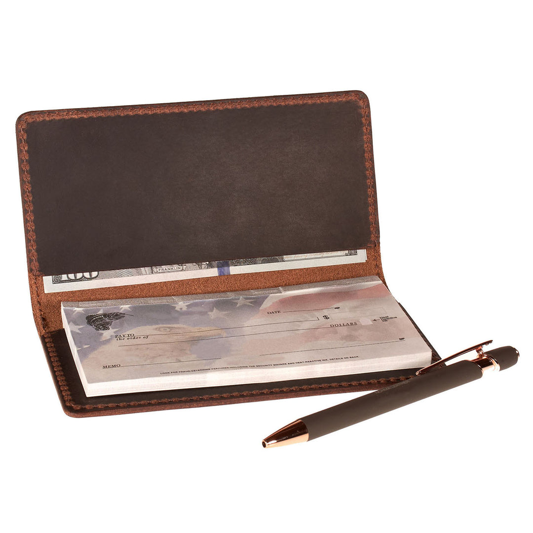 Brown leather checkbook cover with checks and a pen on a white background