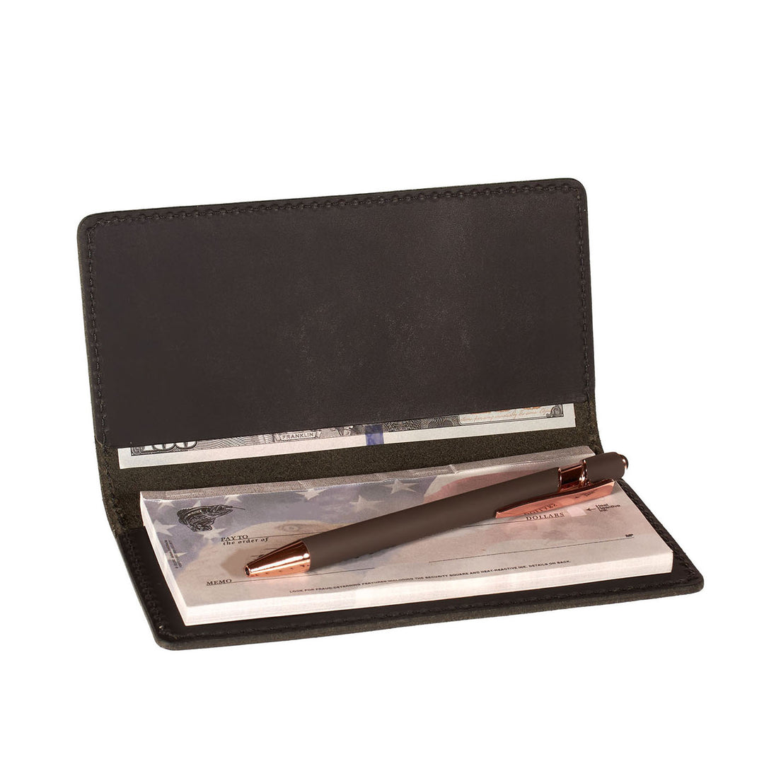 Black leather checkbook cover with pen and money on a white background