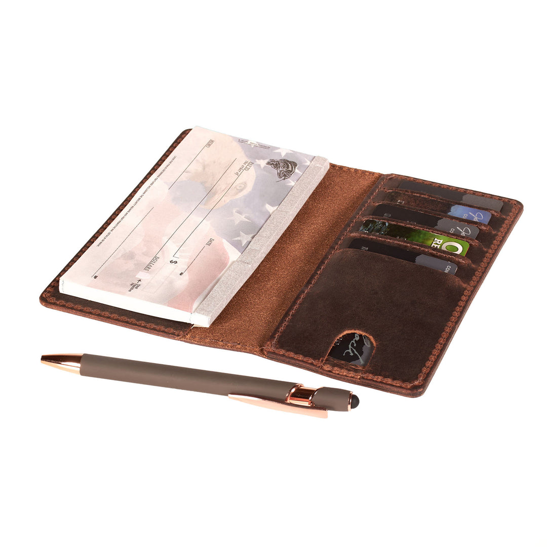 Brown leather checkbook with card slots, pen holder, and paper on a white background