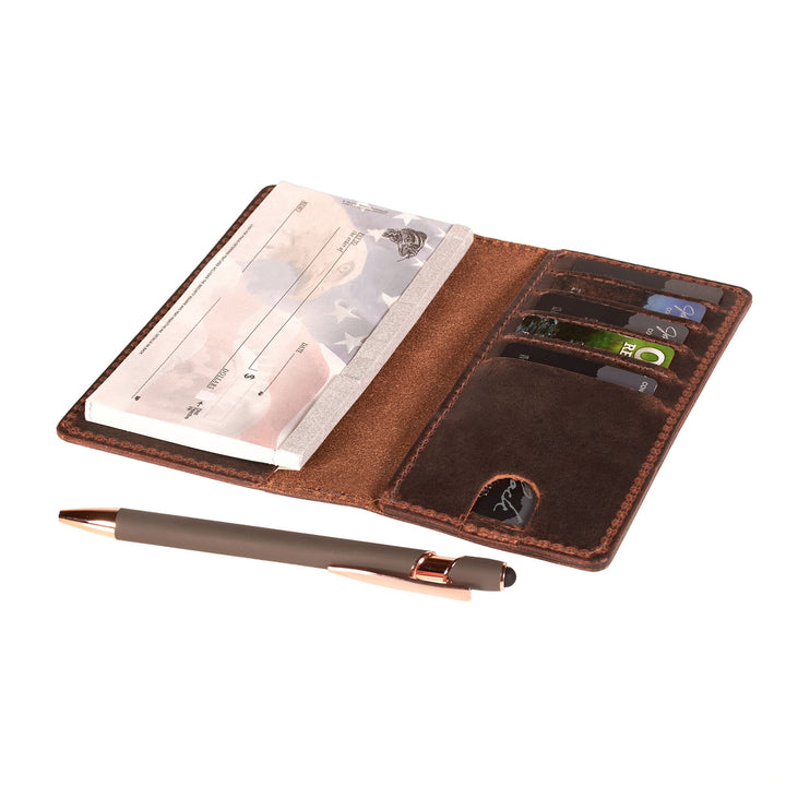 Brown leather checkbook with card slots, pen holder, and paper on a white background