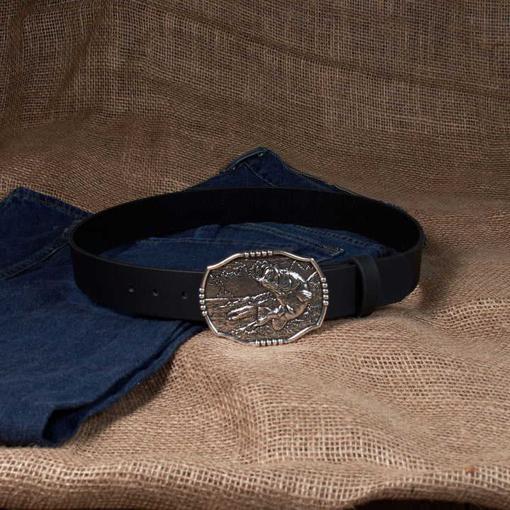 Black belt with a silver buckle on a brown fabric background