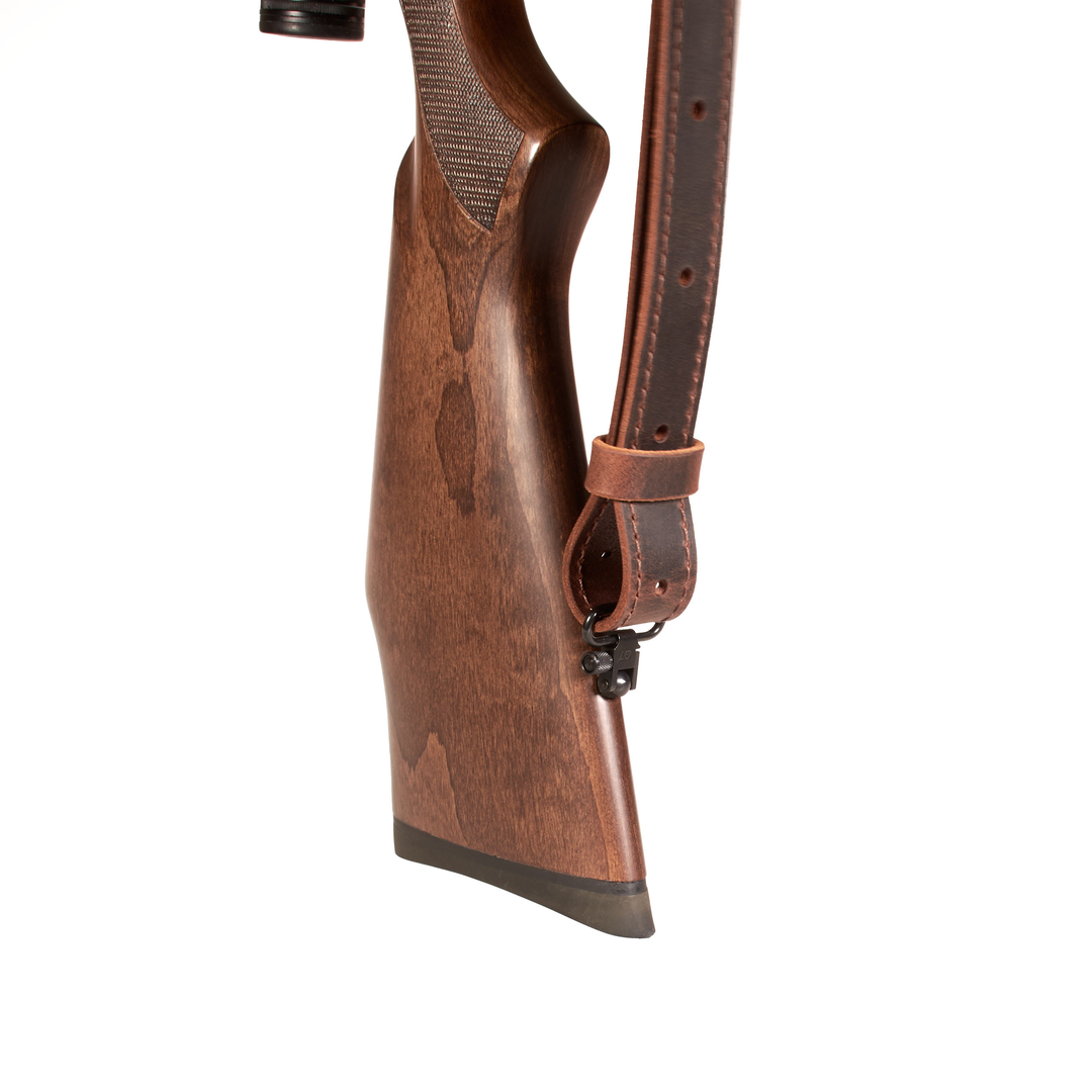 Wooden rifle stock with leather sling on a white background