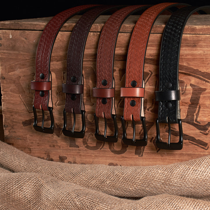 Set of leather belts with different colors on a wooden surface