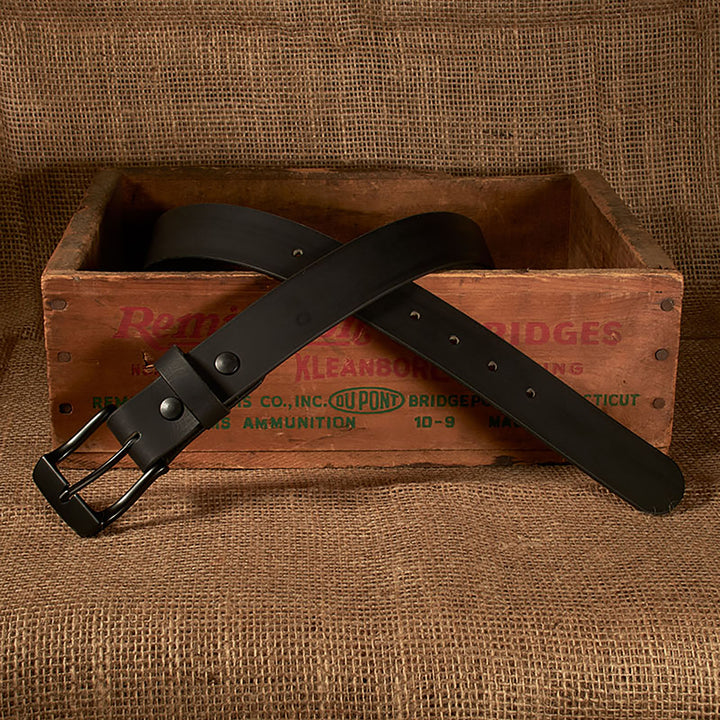 Black belt on a wooden crate with a rustic background