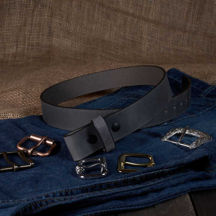 Gray leather belt with various metal buckles on a textured brown background
