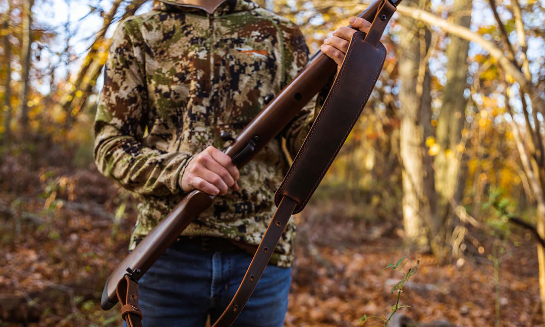 hunter holding a rifle with leather sling