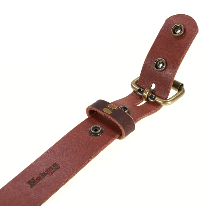 Brown leather strap with brass hardware on a white background